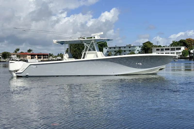 Slide: The Image of 2017 SeaVee 370Z boat on calm water under a partly cloudy sky. - 4