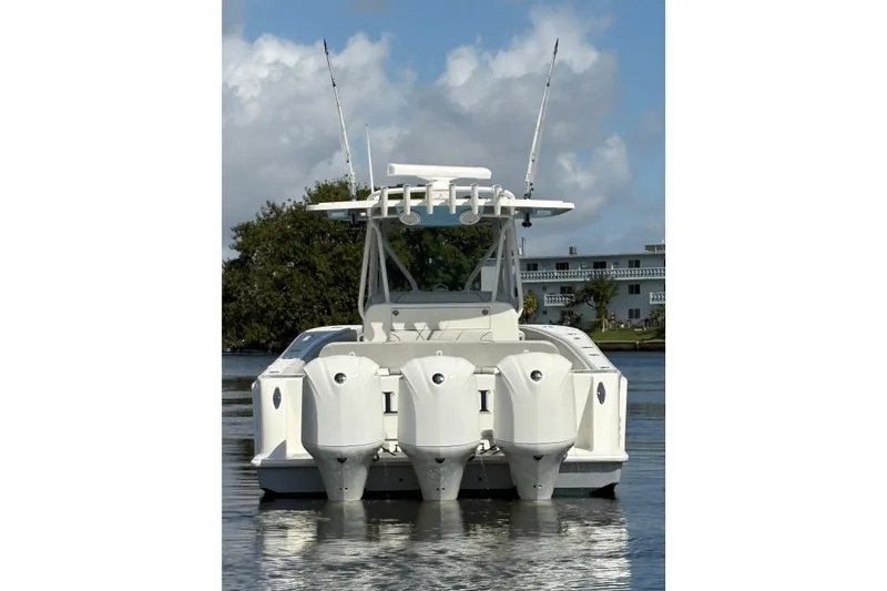Slide: The Image of 2017 SeaVee 370Z boat with triple outboard engines on calm water. - 5