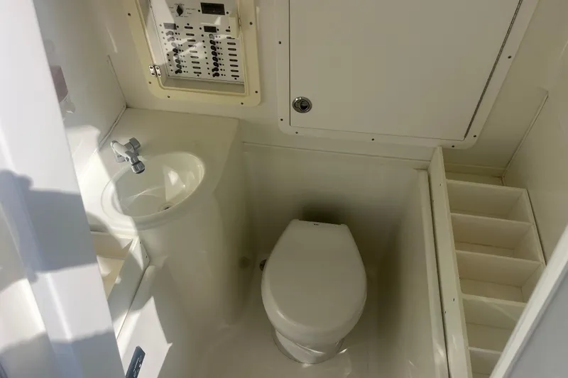 Slide: The Image of 2017 SeaVee 370Z boat bathroom with sink, toilet, and control panel. - 9