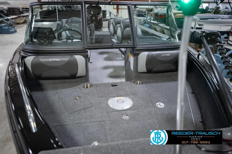 Slide: The Image of Interior view of 2026 Lund 1975 Tyee boat, featuring seating and dashboard. - 12