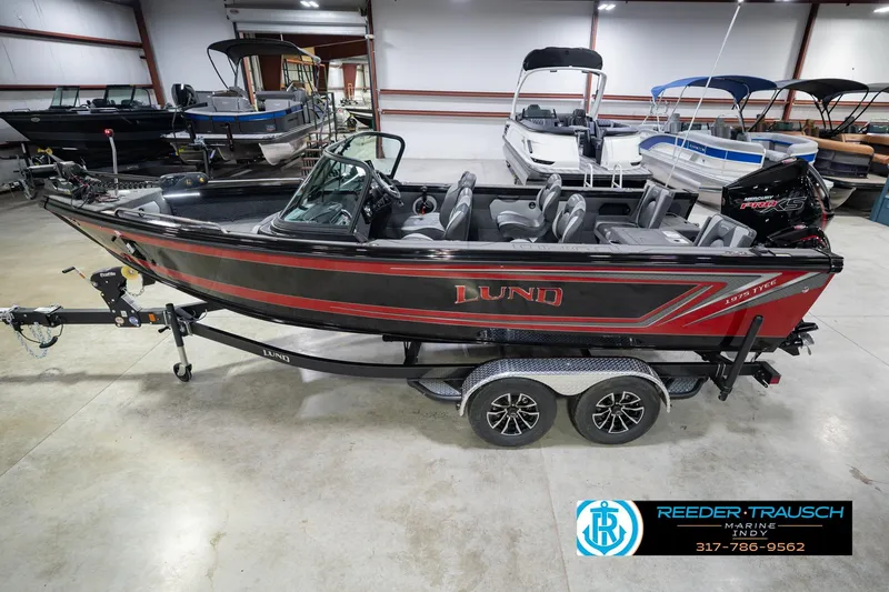 The Image of 2026 Lund 1975 Tyee boat in showroom, side view on trailer. - 2
