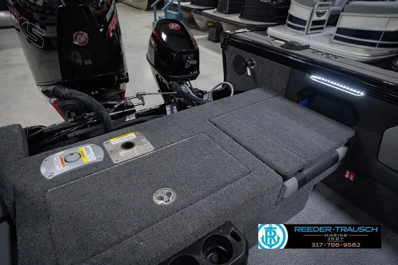 Slide: The Image of 2026 Lund 1975 Tyee boat interior with motor, carpeted deck, and LED lighting. - 22