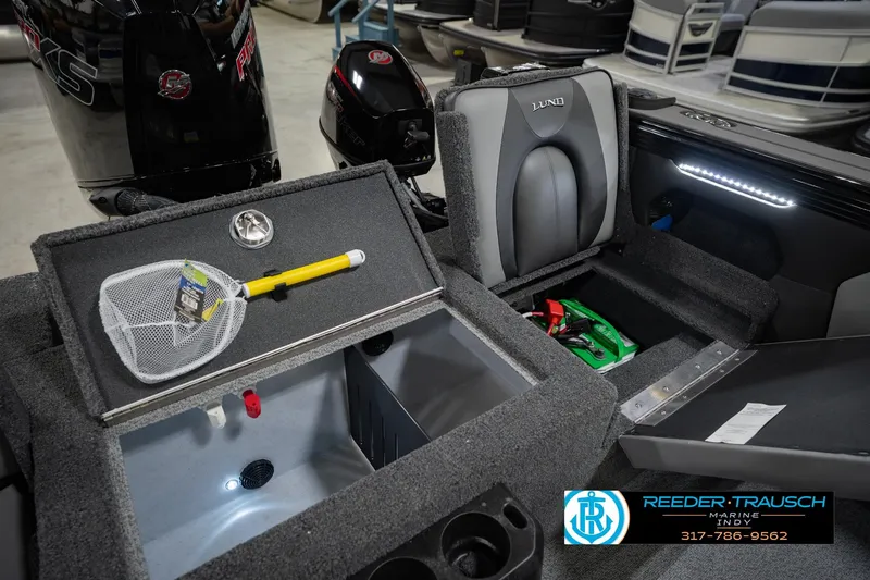 Slide: The Image of Interior of 2026 Lund 1975 Tyee boat with storage compartments and fishing gear. - 23