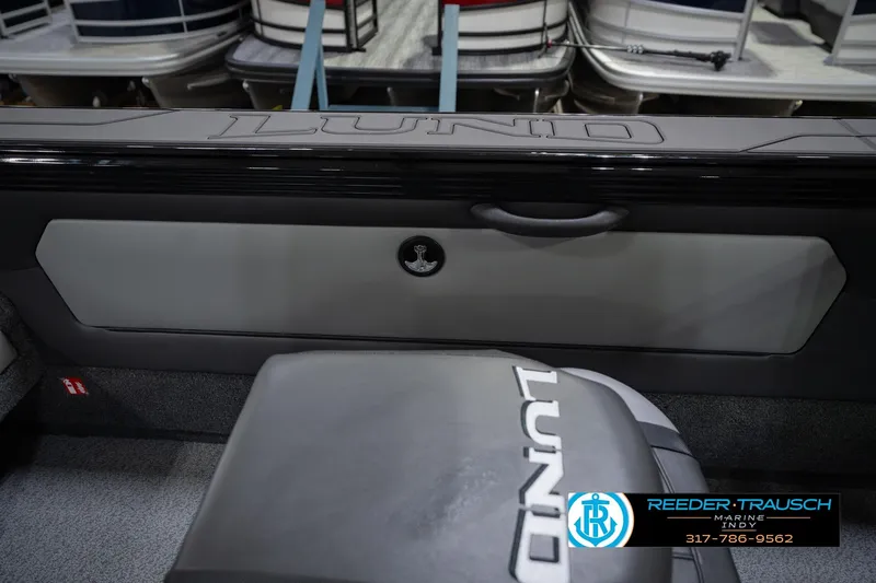 Slide: The Image of 2026 Lund 1975 Tyee boat interior with logo, featuring sleek design and modern upholstery. - 24