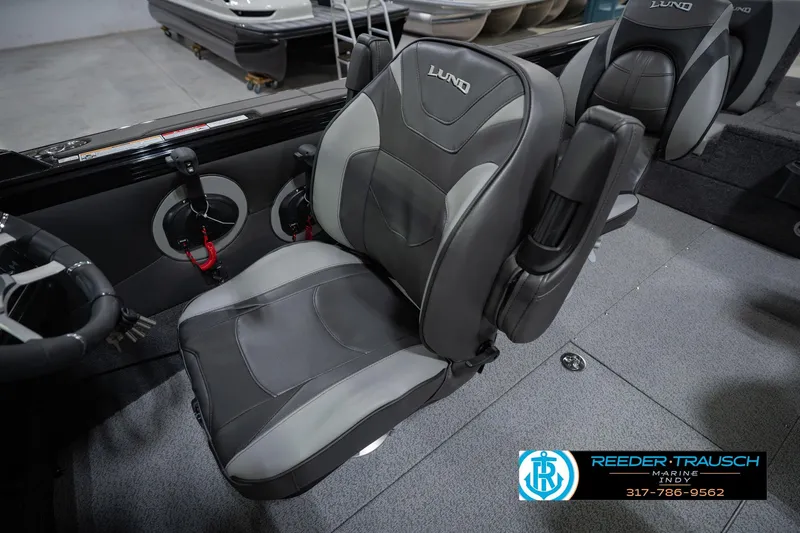 Slide: The Image of 2026 Lund 1975 Tyee boat interior with premium seating and steering wheel. - 26
