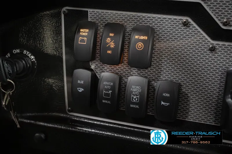 Slide: The Image of Control panel of 2026 Lund 1975 Tyee boat with illuminated switches and key ignition. - 35