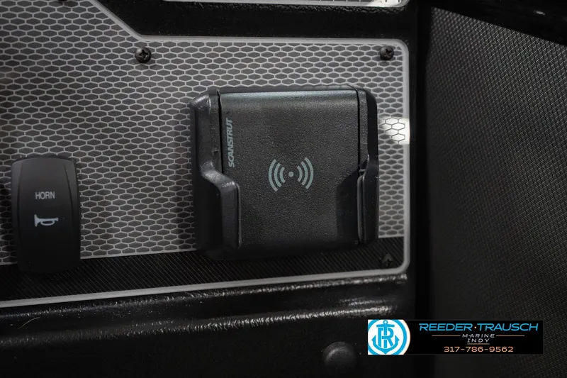 Slide: The Image of Control panel of 2026 Lund 1975 Tyee boat with horn switch and wireless charging pad. - 36
