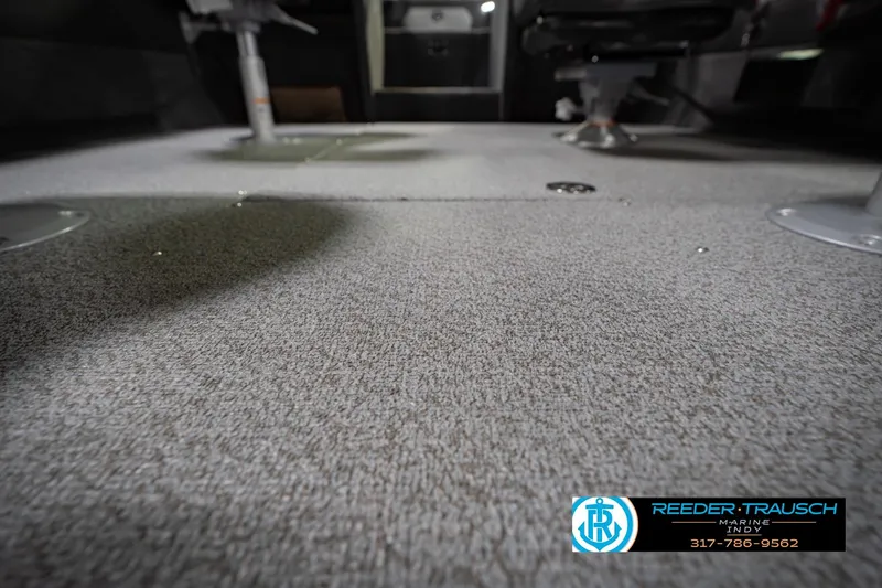 Slide: The Image of Carpeted interior of 2026 Lund 1975 Tyee boat, featuring seating and flooring details. - 47