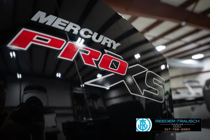 Slide: The Image of Mercury Pro XS engine on a 2026 Lund 1975 Tyee boat in showroom. - 49