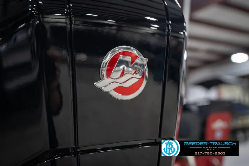 Slide: The Image of Close-up of a 2026 Lund 1975 Tyee boat emblem in a showroom. - 51