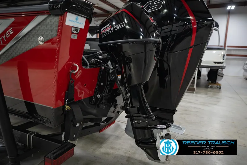 Slide: The Image of 2026 Lund 1975 Tyee boat with Mercury Kicker motor in showroom. - 53