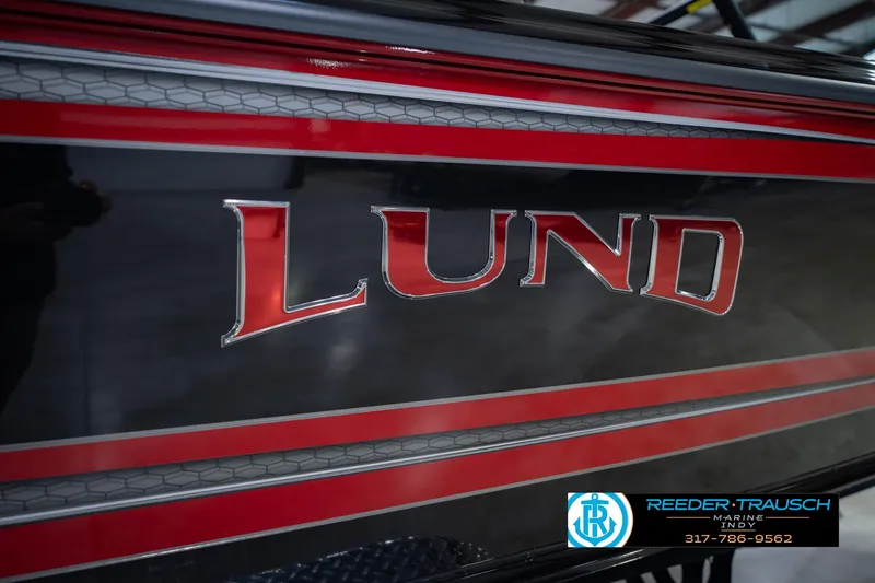 Slide: The Image of Close-up of 2026 Lund 1975 Tyee boat logo with red and black detailing. - 61