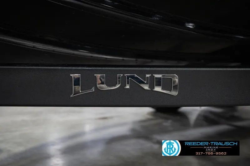 Slide: The Image of Close-up of 2026 Lund 1975 Tyee boat logo with Reeder-Trausch Marine contact. - 65