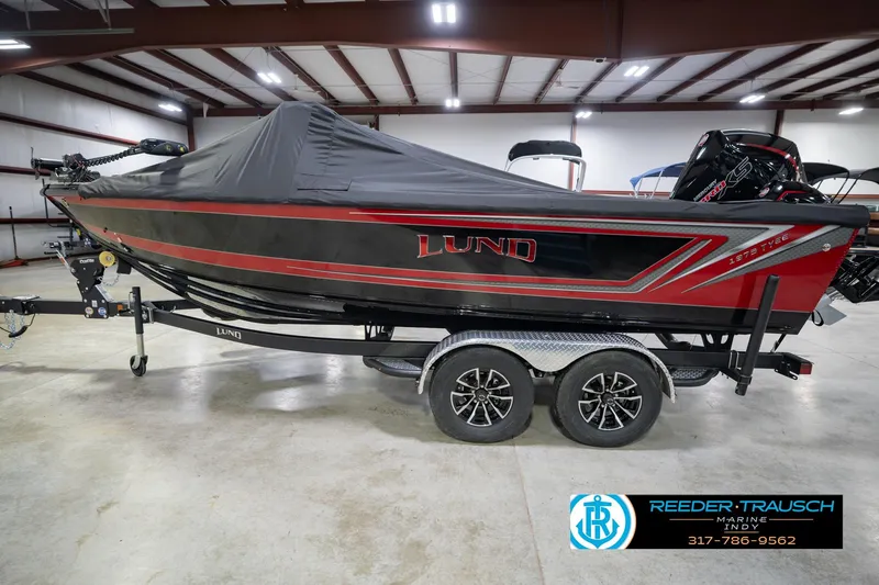Slide: The Image of 2026 Lund 1975 Tyee boat with cover on trailer in indoor showroom. - 67