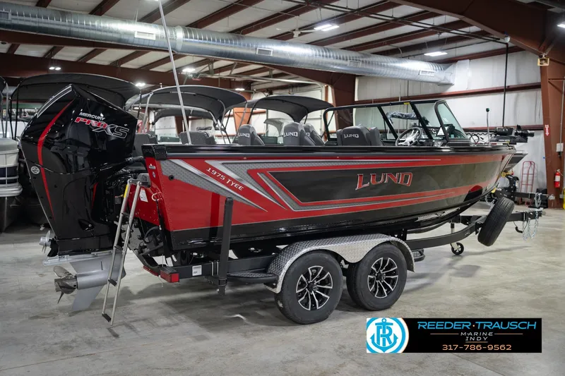 Slide: The Image of 2026 Lund 1975 Tyee boat in showroom, featuring Mercury Pro XS engine. - 7