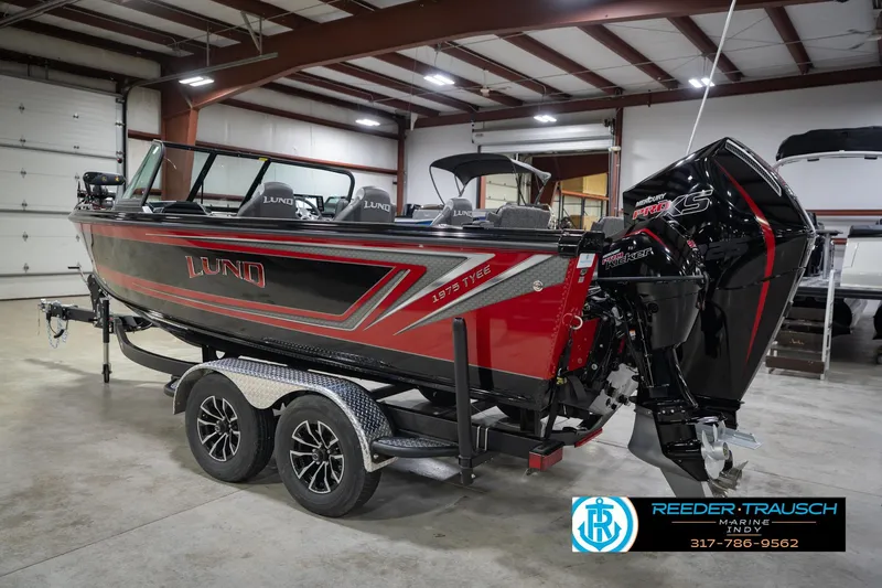 Slide: The Image of 2026 Lund 1975 Tyee boat in showroom, featuring sleek design and powerful Mercury engine. - 9