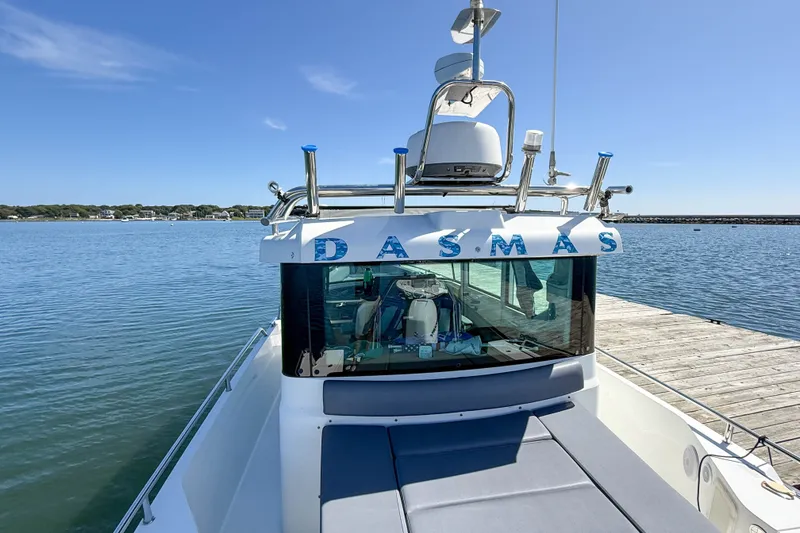 Slide: The Image of 2020 Axopar 28 Cabin boat docked by the water on a sunny day. - 5