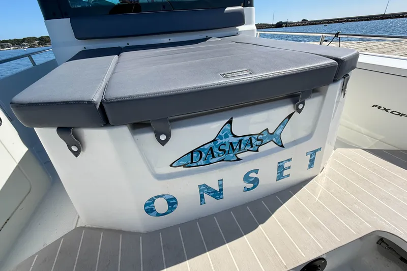 Slide: The Image of 2020 Axopar 28 Cabin boat with custom shark graphic and "ONSET" text on deck. - 29