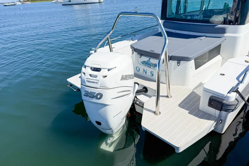 Slide: The Image of 2020 Axopar 28 Cabin boat with Mercury 350 outboard engine on calm water. - 6