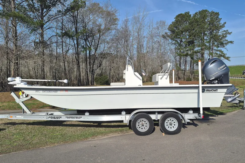The Image of 2024 May-Craft 22 Hancock Skiff on trailer, parked outdoors with trees in background. - 0