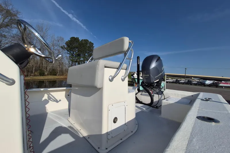 Slide: The Image of 2024 May-Craft 22 Hancock Skiff boat with steering console and outboard motor. - 13