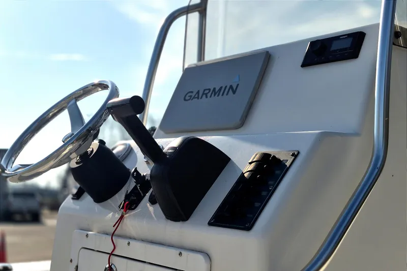 Slide: The Image of 2024 May-Craft 22 Hancock Skiff dashboard with Garmin navigation system and steering wheel. - 14