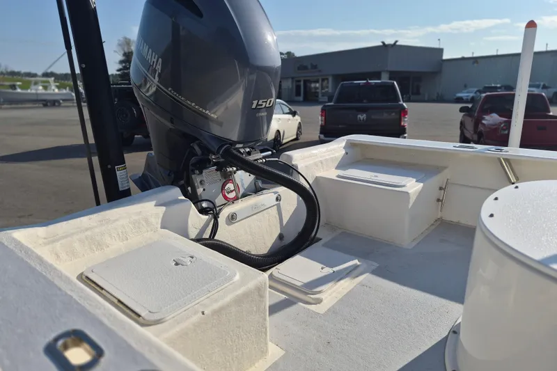 Slide: The Image of 2024 May-Craft 22 Hancock Skiff with Yamaha 150 outboard motor in a parking lot. - 16