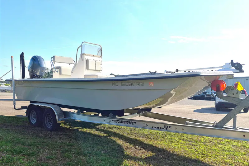 Slide: The Image of 2024 May-Craft 22 Hancock Skiff on trailer, parked outdoors under clear sky. - 4