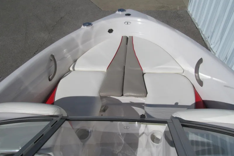 Slide: The Image of 2006 Tahoe Q4 SF boat interior with white and red cushioned seating. - 10
