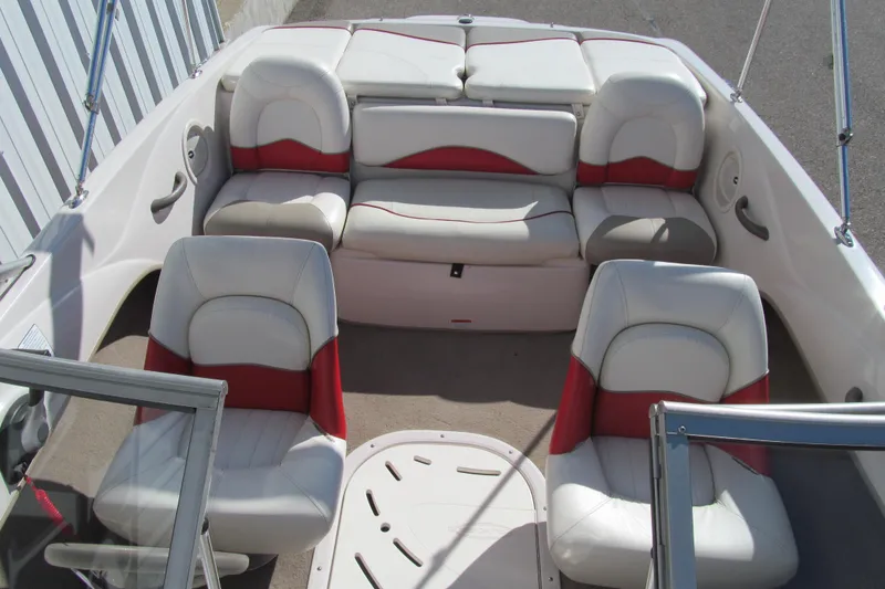Slide: The Image of 2006 Tahoe Q4 SF boat interior with white and red seating arrangement. - 12