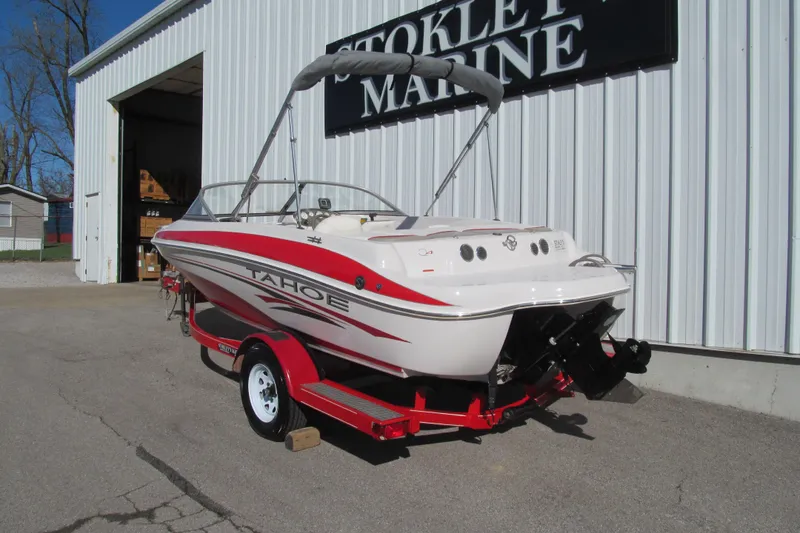 Slide: The Image of 2006 Tahoe Q4 SF boat on trailer outside marine shop. - 3