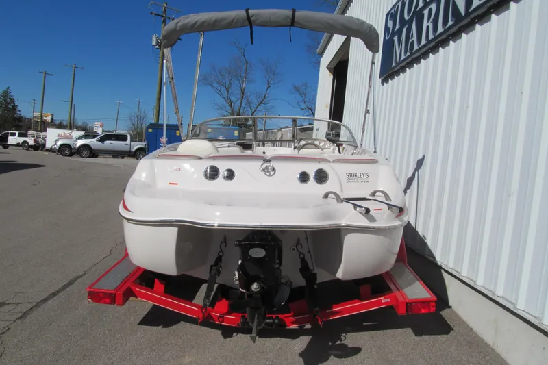 Slide: The Image of 2006 Tahoe Q4 SF boat on red trailer outside marine shop. - 4