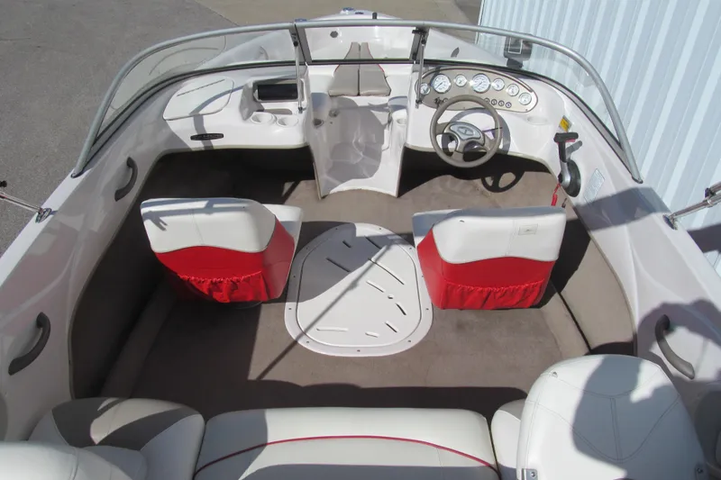 Slide: The Image of 2006 Tahoe Q4 SF boat interior with red and white seating, steering wheel, and dashboard. - 6