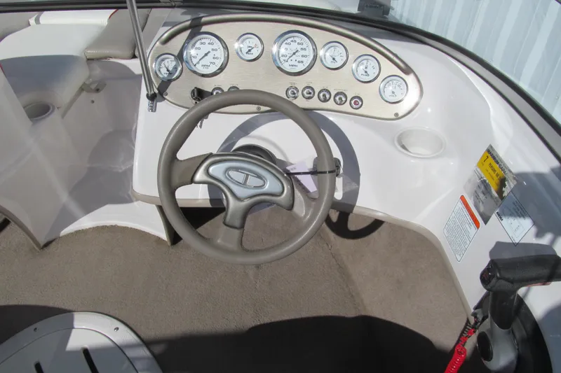 Slide: The Image of Steering console of a 2006 Tahoe Q4 SF boat with gauges and controls. - 7