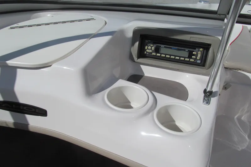 Slide: The Image of 2006 Tahoe Q4 SF boat dashboard with stereo and cup holders. - 8
