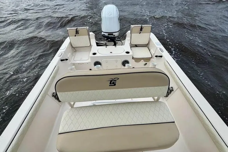 Slide: The Image of 2024 Carolina Skiff 23 LS boat interior with seating and motor on water. - 11