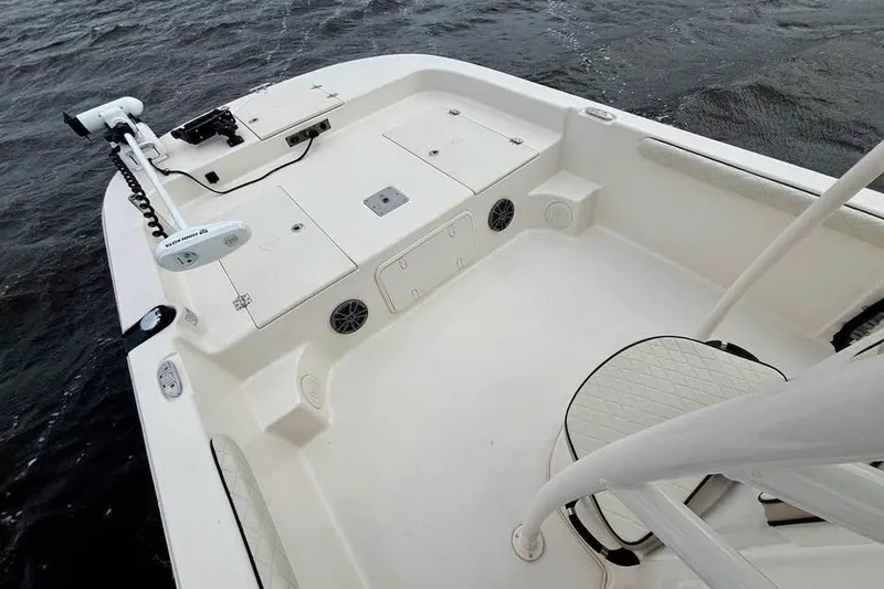 Slide: The Image of 2024 Carolina Skiff 23 LS boat interior with seating and storage on water. - 7