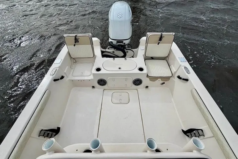 Slide: The Image of 2024 Carolina Skiff 23 LS boat interior with seating and motor on water. - 8