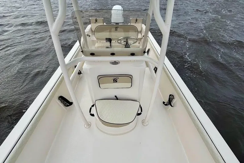 Slide: The Image of 2024 Carolina Skiff 23 LS boat interior with seating and console on water. - 9