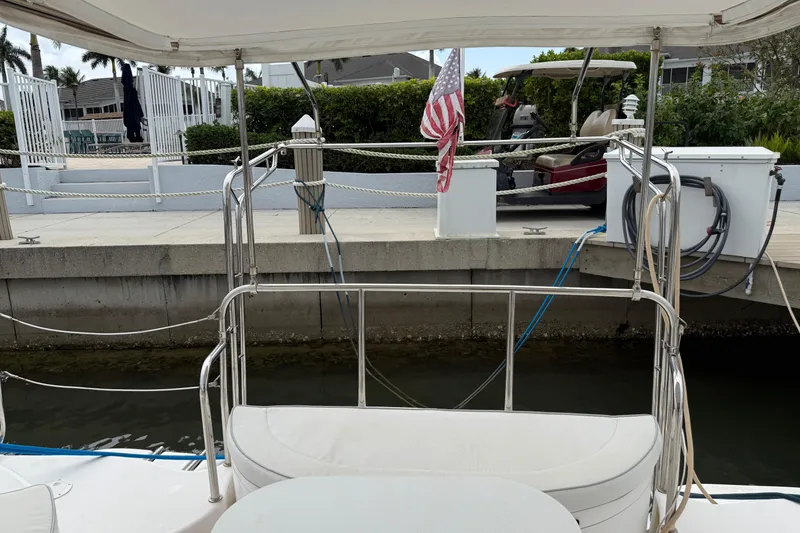 Slide: The Image of Docked Gemini Legacy 35 sailboat, 2014 model, with American flag and marina view. - 12