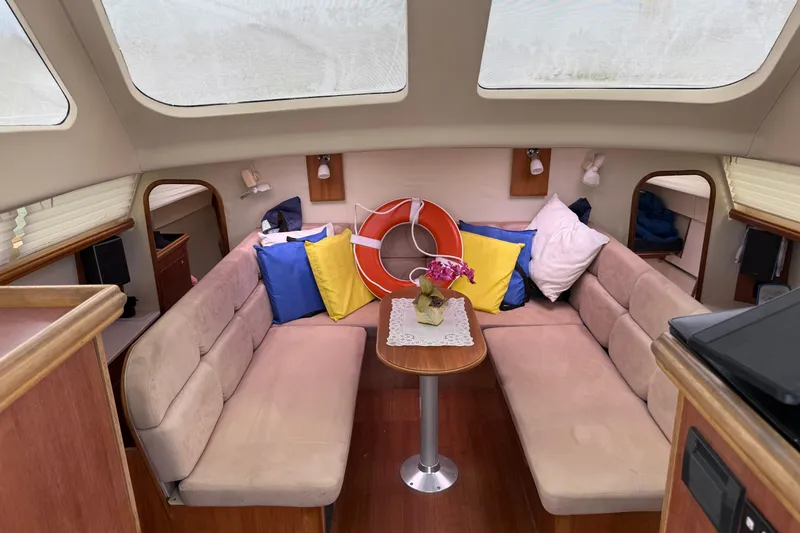Slide: The Image of Interior of 2014 Gemini Legacy 35 sailboat with cozy seating and colorful cushions. - 14