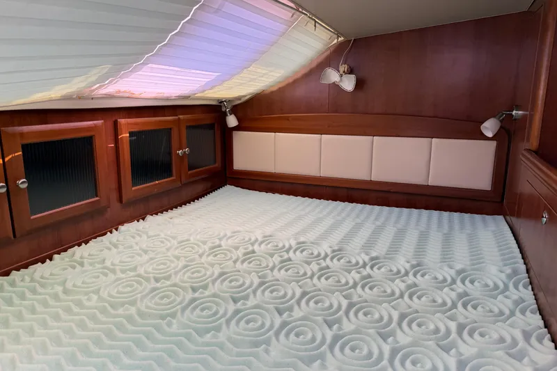 Slide: The Image of Cozy cabin interior of 2014 Gemini Legacy 35 with patterned mattress and wooden cabinetry. - 16