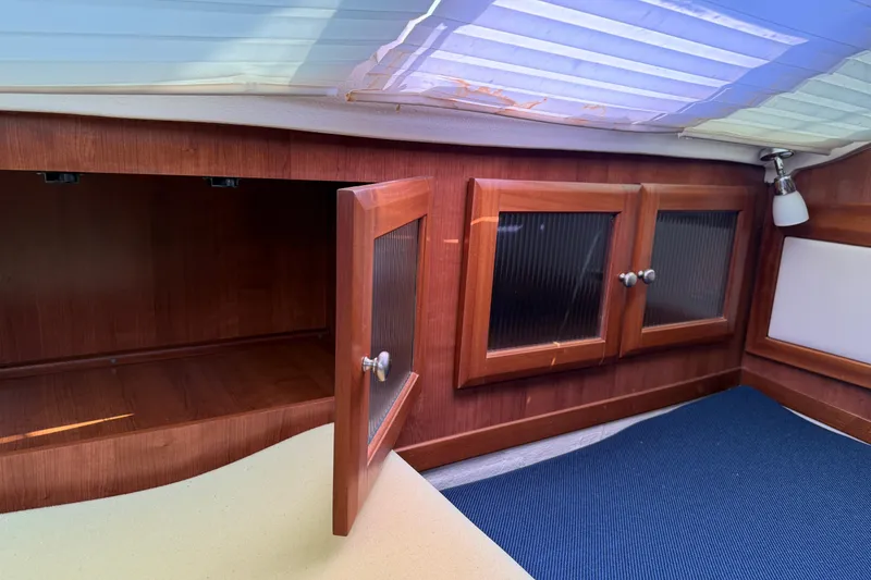 Slide: The Image of Interior of 2014 Gemini Legacy 35 sailboat with wooden cabinets and blue mat. - 17