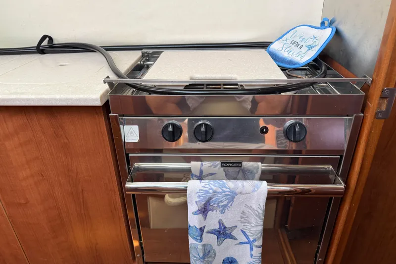 Slide: The Image of Stainless steel stove in 2014 Gemini Legacy 35 boat kitchen with nautical-themed towel. - 20