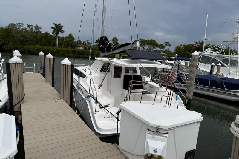 Slide: The Image of 2014 Gemini Legacy 35 catamaran docked at marina with solar panel and American flag. - 3