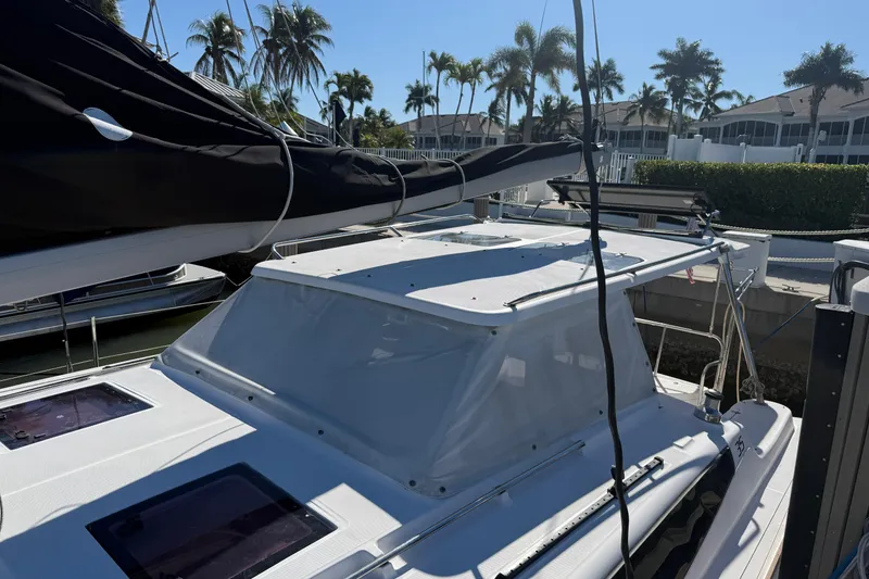 Slide: The Image of 2014 Gemini Legacy 35 catamaran docked, featuring sleek design and tropical palm tree backdrop. - 5