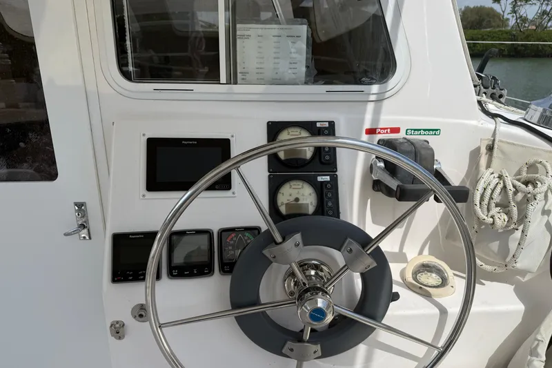 Slide: The Image of Steering wheel and controls of a 2014 Gemini Legacy 35 boat cockpit. - 8