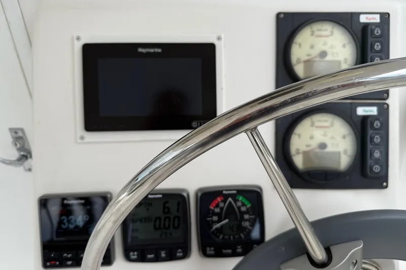 Slide: The Image of Cockpit instruments of a 2014 Gemini Legacy 35 sailboat with steering wheel. - 9
