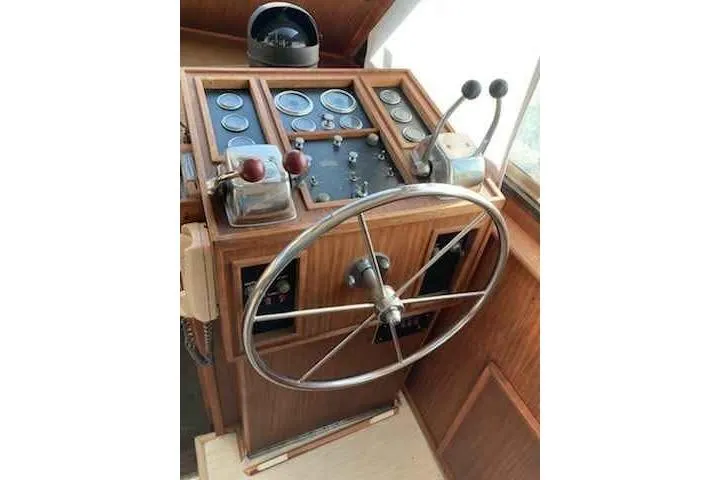 Slide: The Image of 1979 Hatteras 46 Convertible helm with wooden dashboard and steering wheel. - 11