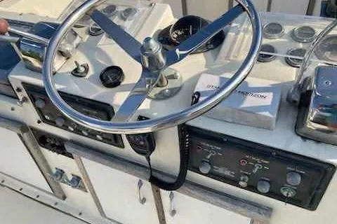 Slide: The Image of 1979 Hatteras 46 Convertible yacht helm with steering wheel and control panel. - 13